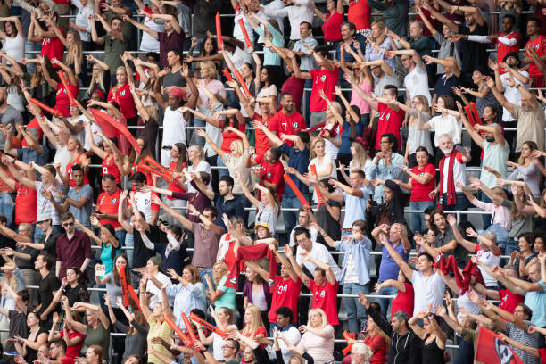 istock Group of spectators cheering in stadium 1129816145