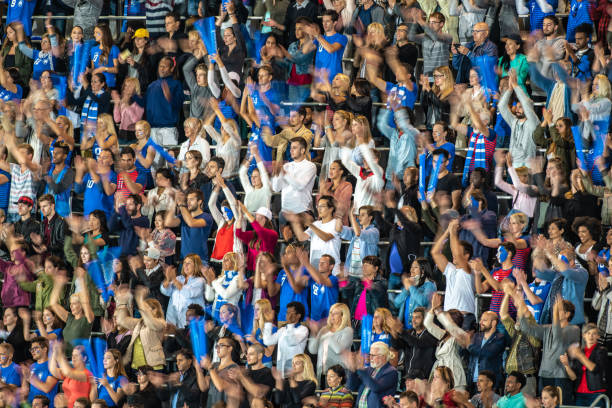 istock Group of spectators cheering in stadium 1129816148
