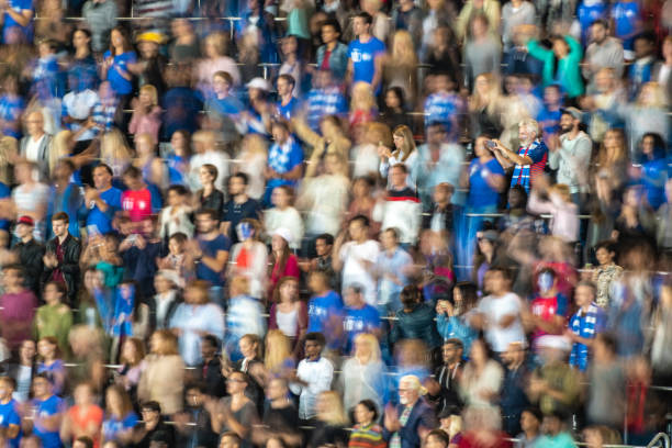 istock Group of spectators cheering in stadium 1129816150