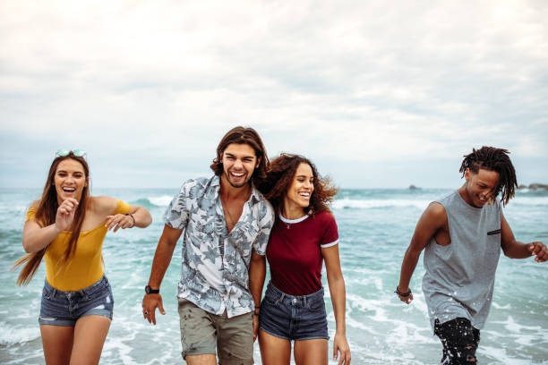 istock Carefree friends having fun along the beach 1129818442