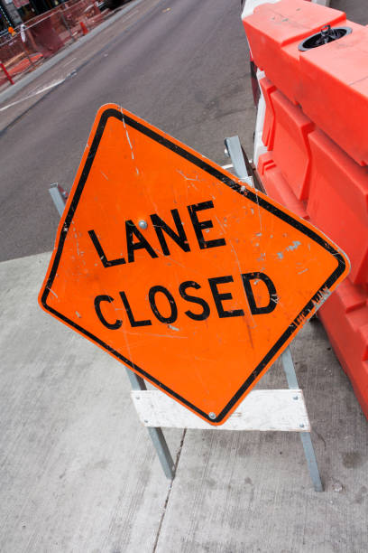 lane closed road sign on street
