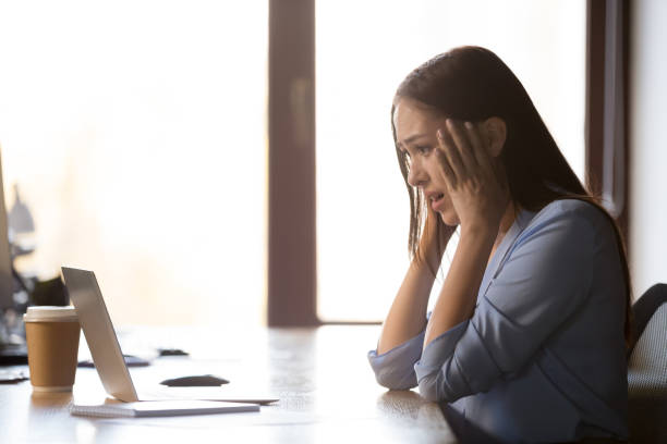 istock Shocked female look at laptop see warning notice 1129819885