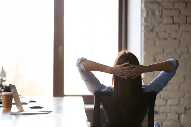Female relax in chair leaning back hands over head