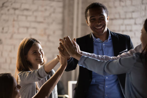 istock Diverse colleagues give high five celebrating business success 1129819929