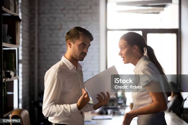 Diverse Employees Argue Over Financial Report In Office Stock Photo - Download Image Now