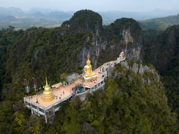 Aerial panoramic photo of Buddha on the top of Tiger Cave Temple, Wat Thum Sua, in Krabi, Thailand. Aerial image of big Buddha on the top of Tiger Cave Temple, Wat Thum Sua, Krabi, Thailand. wat tham sua stock pictures, royalty-free photos & images