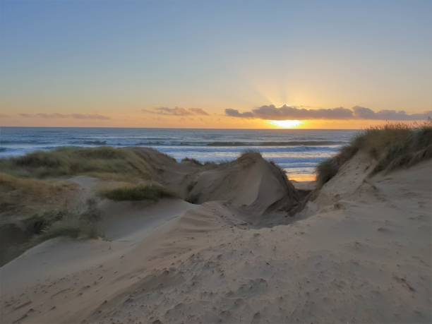 istock Sunrise over sea and dunes 1129821368