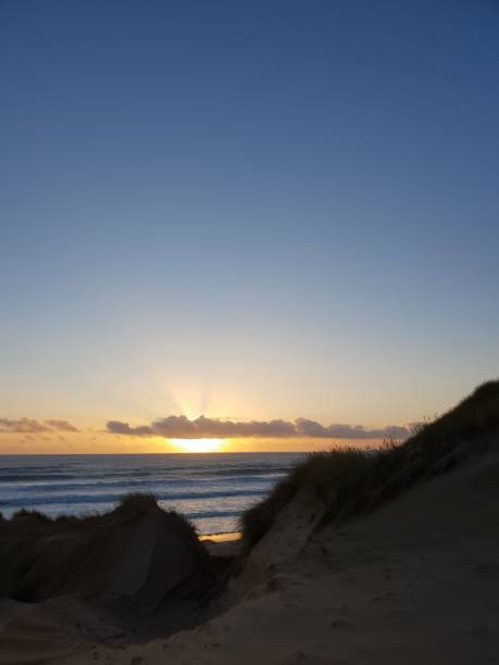 istock Sunrise over sea and dunes 1129821375