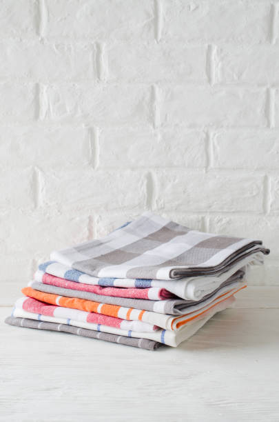 istock Stack of kitchen towels or napkins in interior of white kitchen. 1129821694