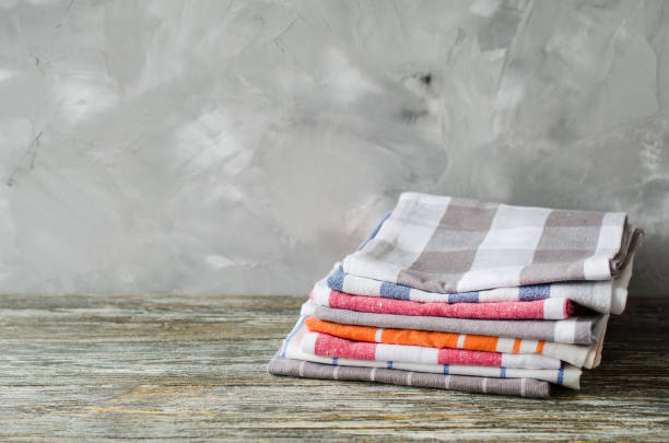 istock Stack of kitchen towels or napkins over the rustic wooden table. 1129821764