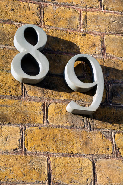 istock Number eighty nine on exterior wall in strong sunshine 1129821841