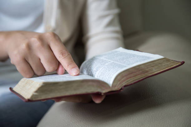 istock Women reading the Holy Bible,Reading a book. 1129822381