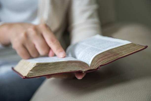 istock Women reading the Holy Bible,Reading a book. 1129822912
