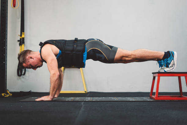 istock Fit athlete in an elevated plant position 1129822963