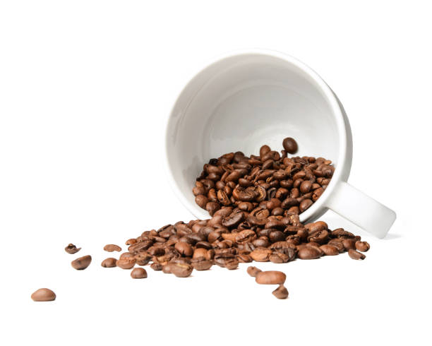 istock Coffee beans scattered from a fallen cup. White isolated background. 1129824472