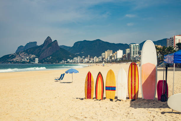 Ipanema beach  with surfboards and parasol Sunny day on Arpoadar Beach, the end of Ipanema where there is surfing two brothers mountain stock pictures, royalty-free photos & images