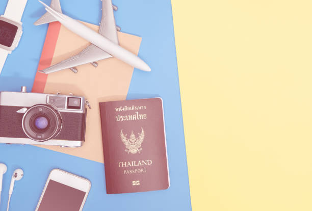istock travel objects and accessories on blue yellow background with passport camera and plane 1129827208