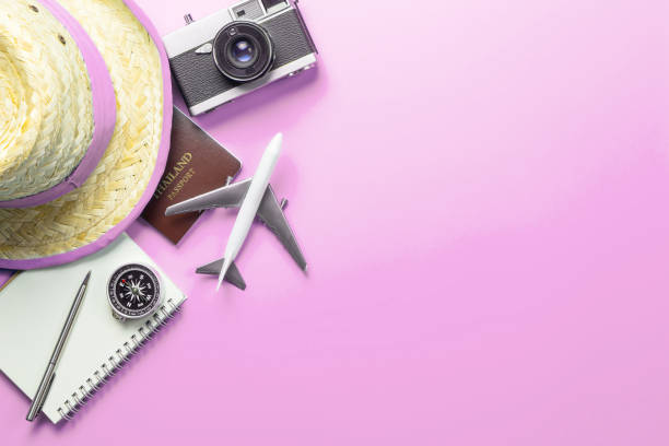 istock Travel accessories objects and gadgets top view flatlay on pink pastel 1129827244