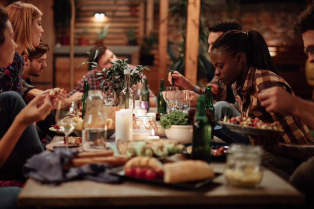 istock Happy friends enjoying dinner party at yard 1129829527