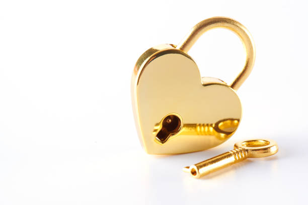 istock Golden lock with a key on a white background. Love concept St. Valentine's Day 1129829942