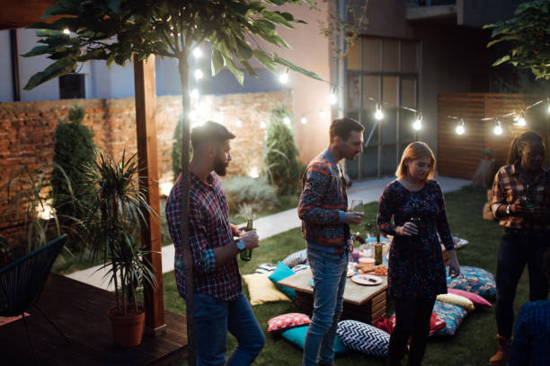 istock Happy friends enjoying dinner party at yard 1129829991