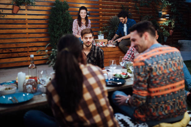 istock Joyful friends having a dinner party during the night 1129830030