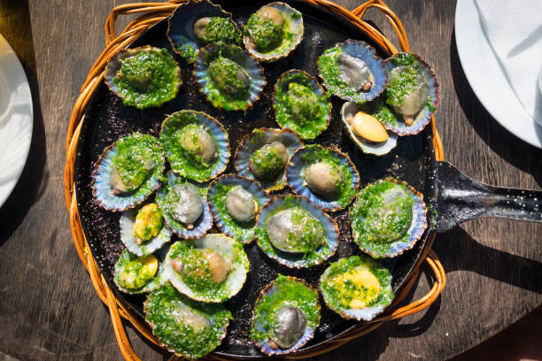 grilled limpets with green mojo, typical avocado in Lanzarote, Canary Island stock photo