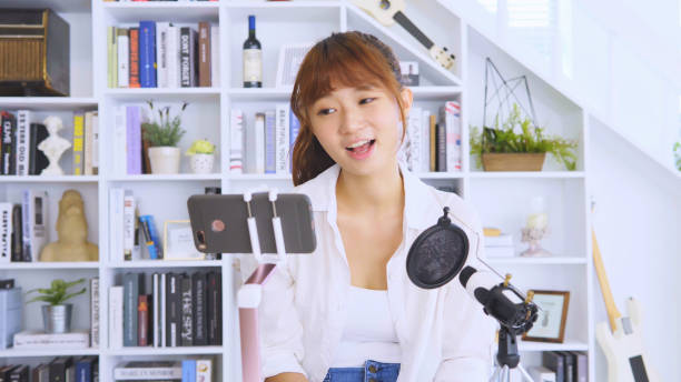 istock Woman having live stream on cellphone 1129833111
