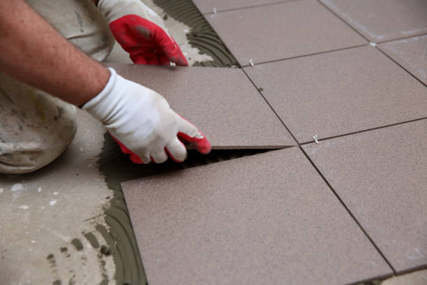 istock The builder arranges ceramic tiles on the stairs inside the building. 1129834520