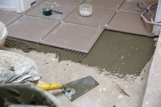 istock The builder arranges ceramic tiles on the stairs inside the building. 1129835019