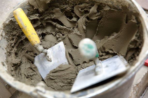 istock A plastic construction bucket with cement based glue ready to be used for gluing ceramic tiles. 1129835206