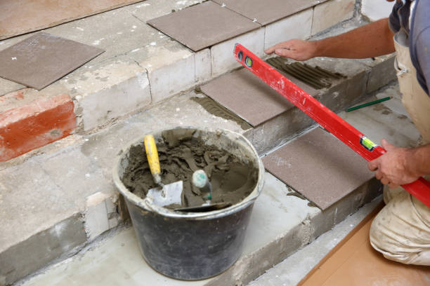 istock Measurement with a spirit level if the tile is evenly arranged on the steps. 1129835359