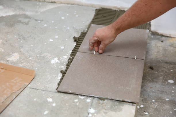 istock The builder arranges ceramic tiles on the stairs inside the building. 1129836451