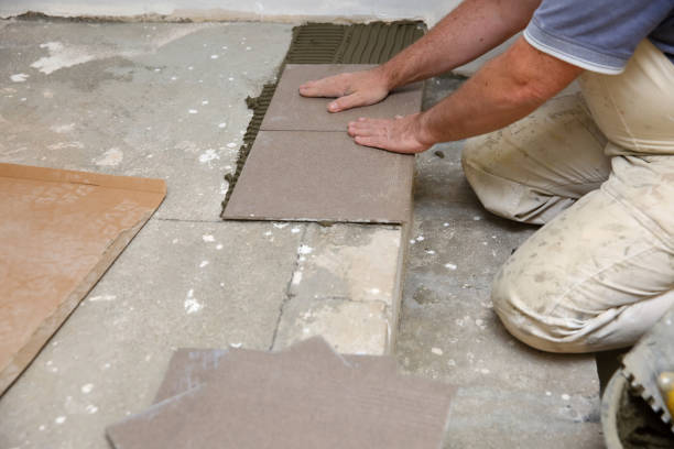istock The builder arranges ceramic tiles on the stairs inside the building. 1129836525