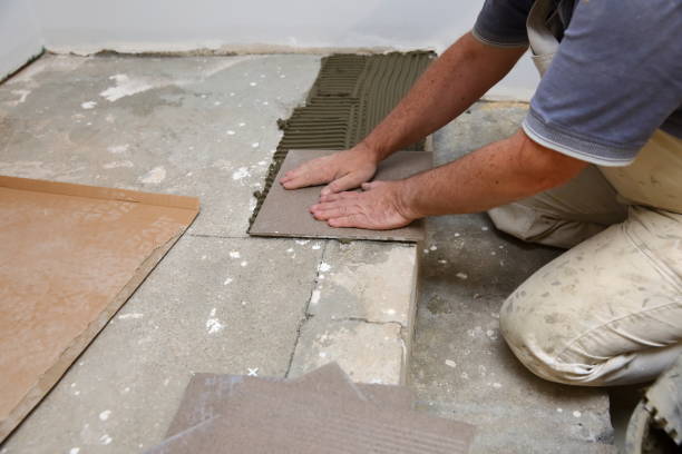 istock The builder arranges ceramic tiles on the stairs inside the building. 1129836700