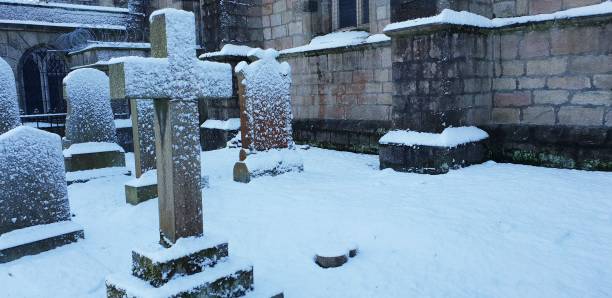 istock Graves, headstones and tombstones in snow-covered cemetery 1129837897