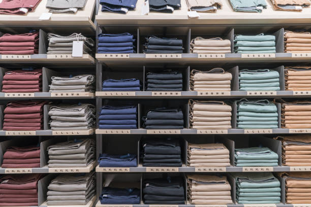 istock Various color shirts at shelf in shop 1129838159