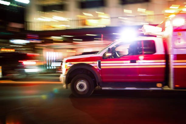 Motion blurred ambulance speeding down street in New York City, USA.