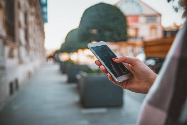 istock Cropped image of young woman using mobile phone 1129840197