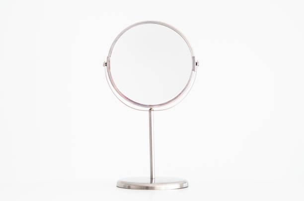istock Single magnifying beauty mirro on stand isolated against pure white front view 1129840490