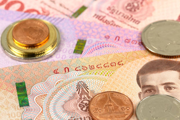 istock some thai baht bank notes and coins 1129848569