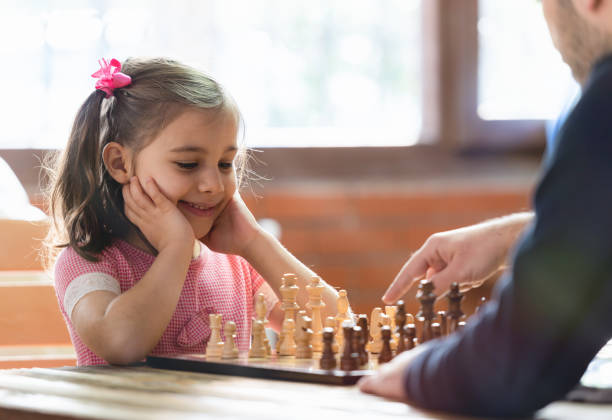 istock Father Teaching His Daughter to Play Chess At Home 1129848950