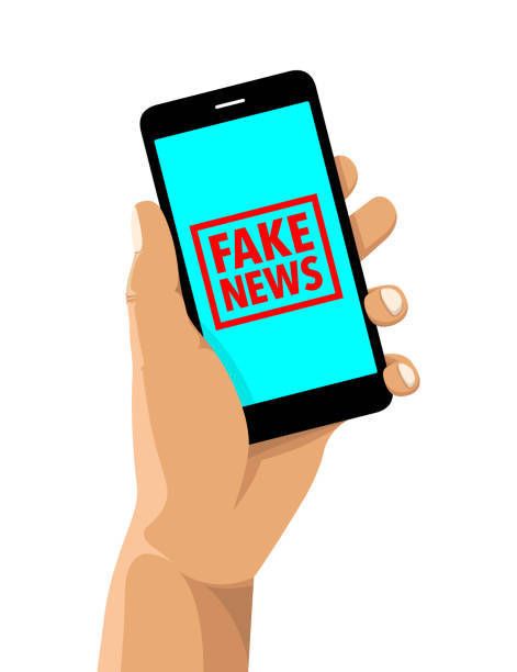 istock Fake news rubber stamp on a cell phone 1129849237