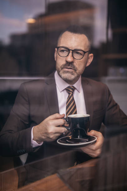 istock Senior man with eyeglasses drinking coffee 1129850195