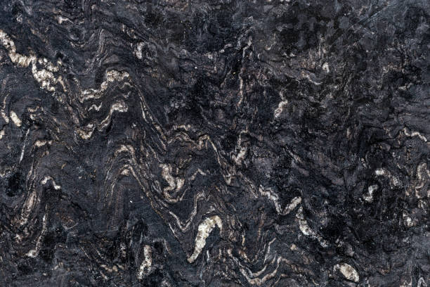 istock Texture of natural polished dark stone. Abstract background 1129851179