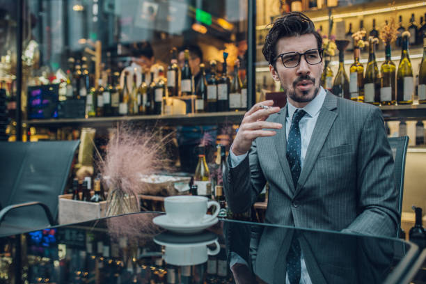 istock Businessman smoking cigarette on a coffee break 1129851708