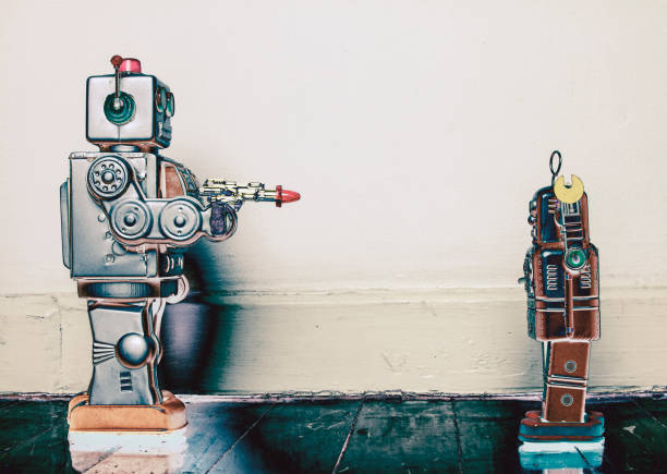 istock concept gun crime with retro toy robots solarized 1129853096