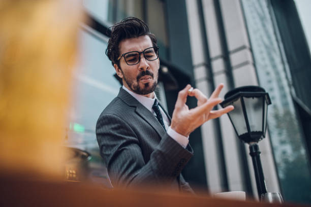 istock Businessman throwing away cigarette 1129854702