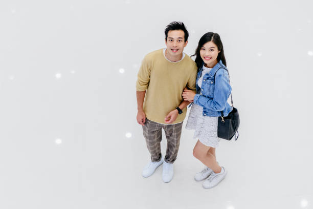 istock Cheerful Chinese couple smiling towards camera 1129855241