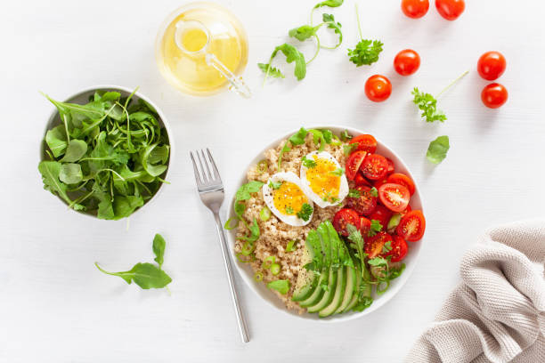istock quinoa with boiled egg, avocado, tomato, arugula. healthy breakfast 1129860899
